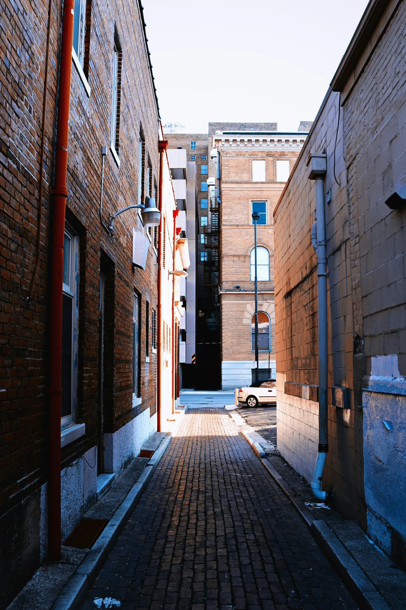 A quiet passage between historic brick buildings.